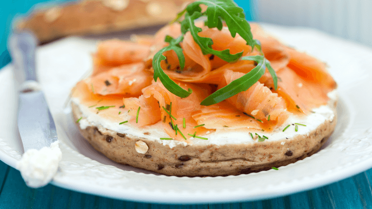 bagel with cream cheese and smoked salmon on a plate