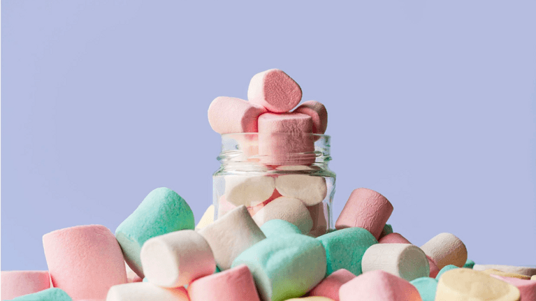 pile of marshmallows overflowing from a glass jar